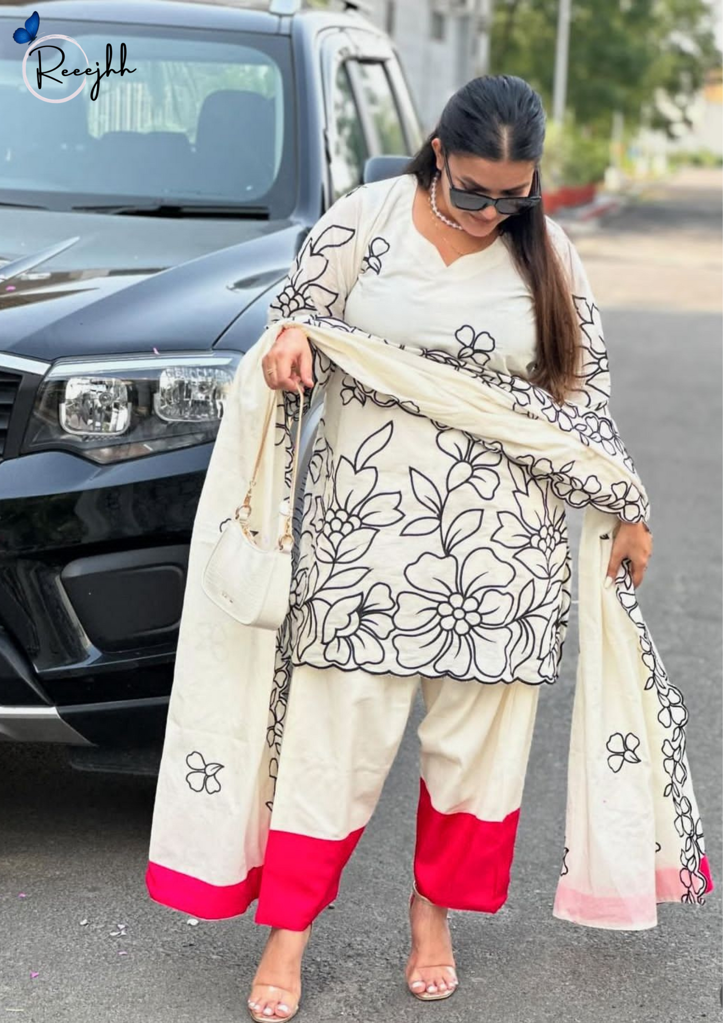 Elegant in white & black florals with a pop of pink – timeless Punjabi charm